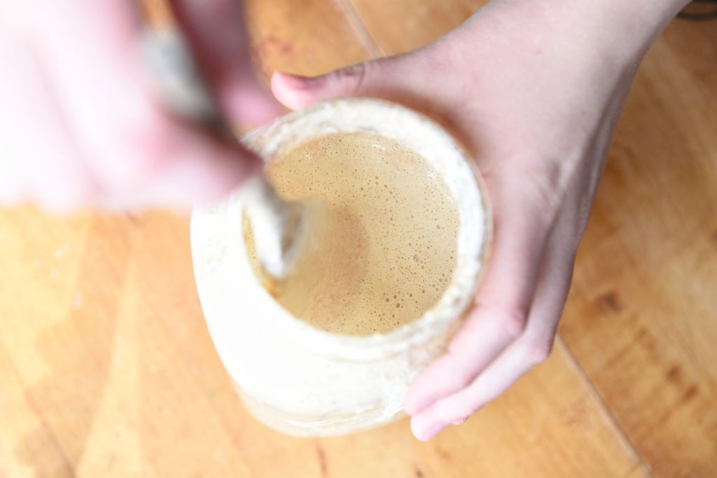 stirring a jar of finished sourdough starter