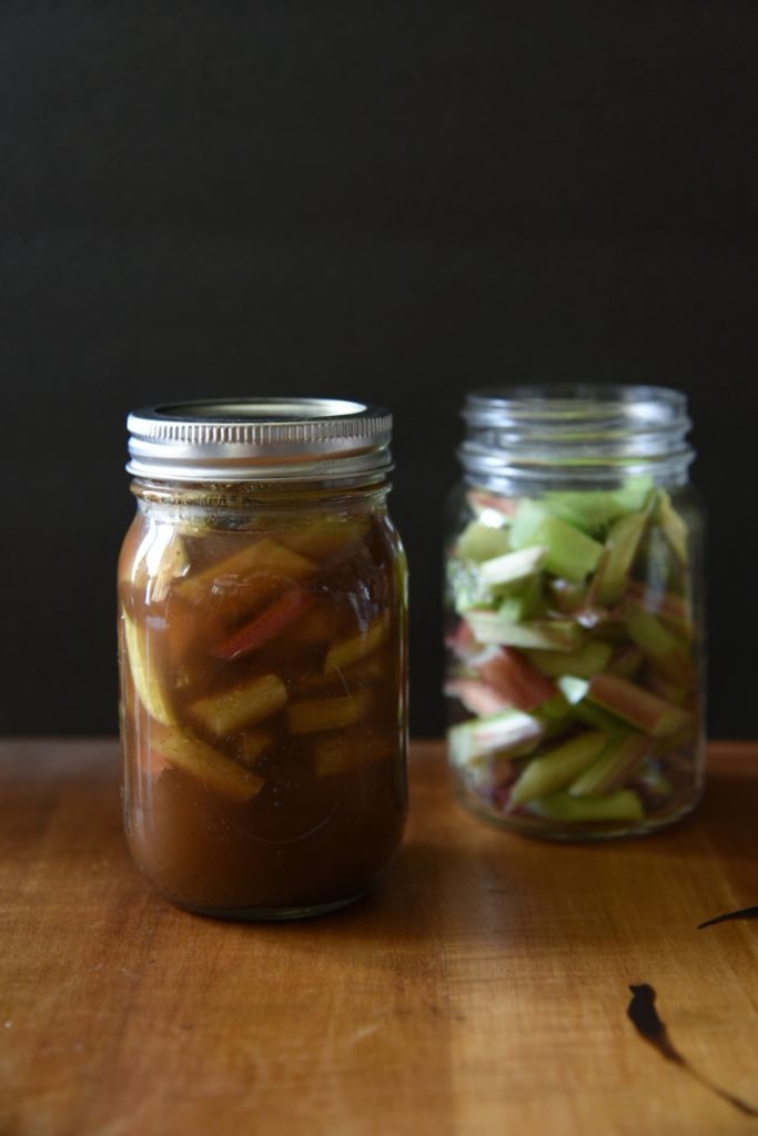 a jar of pickled rhubarb with a jar of chopped rhubarb behind it.