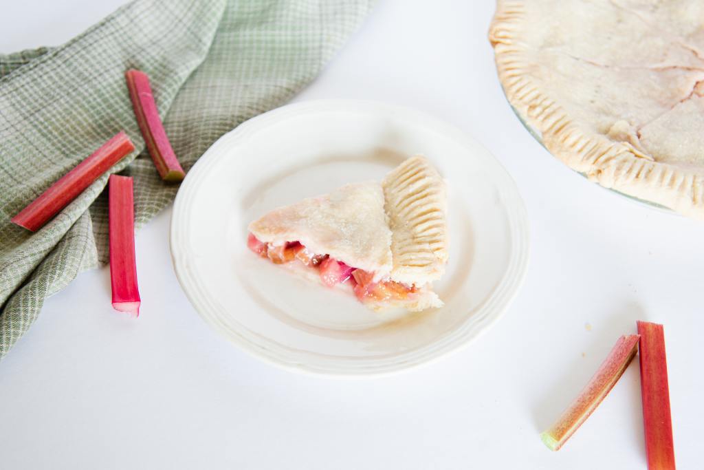 a close up of a rhubarb pie with a slice taken out of it