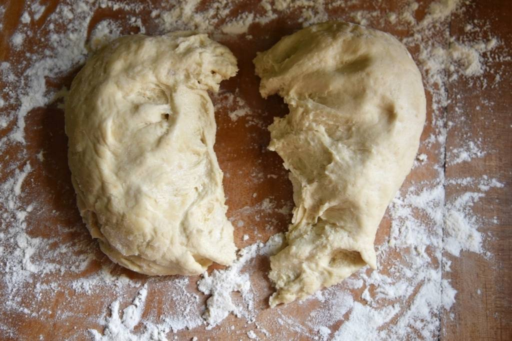 dough divided into two halves and set on the table