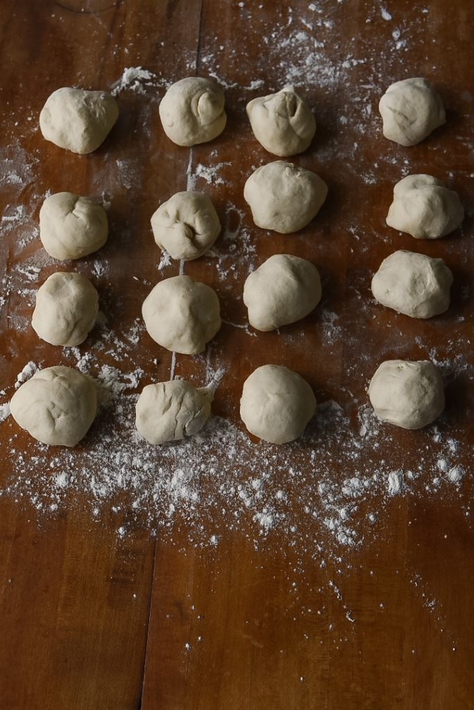 small balls of dough sitting in rows on a table