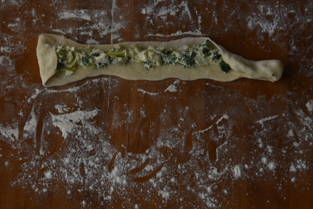 filling being rolled up in the dough