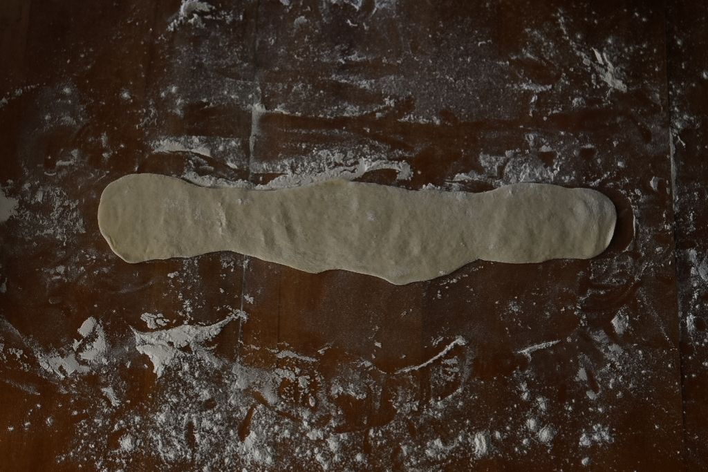 a rolled out cylinder of dough