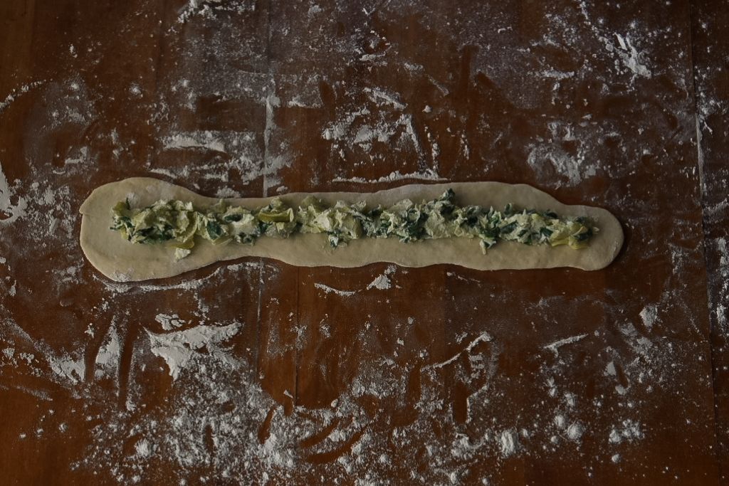 rolled out dough with filling on it