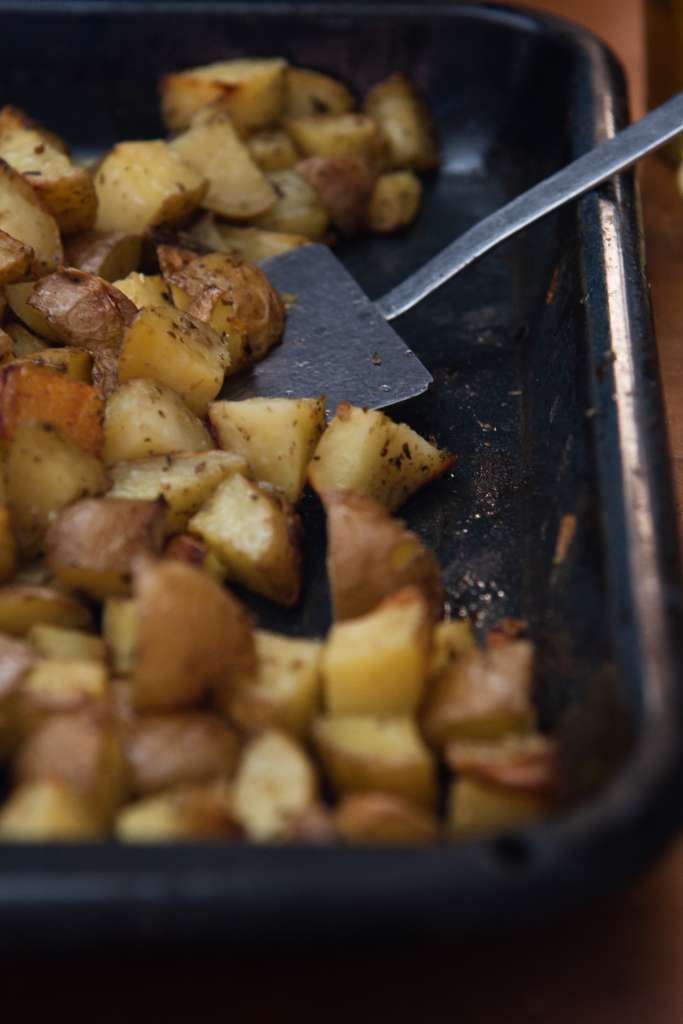 a pan of potatoes with spatula in it
