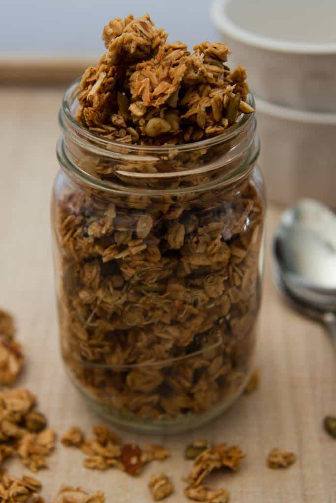 a close up picture of a mason jar full of  granola