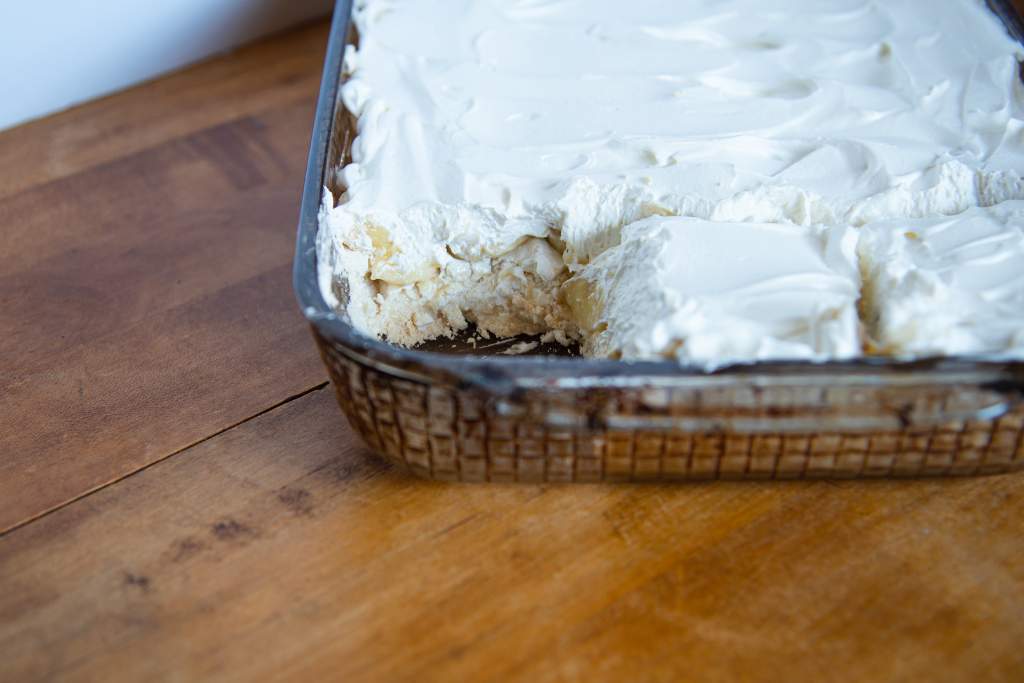 a pan of a banana torte with piece taken of it