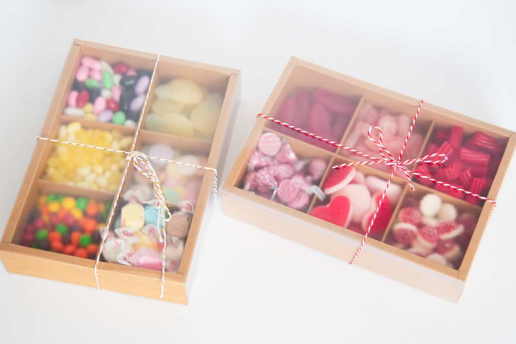 two finished candy boxes with string tied on them 