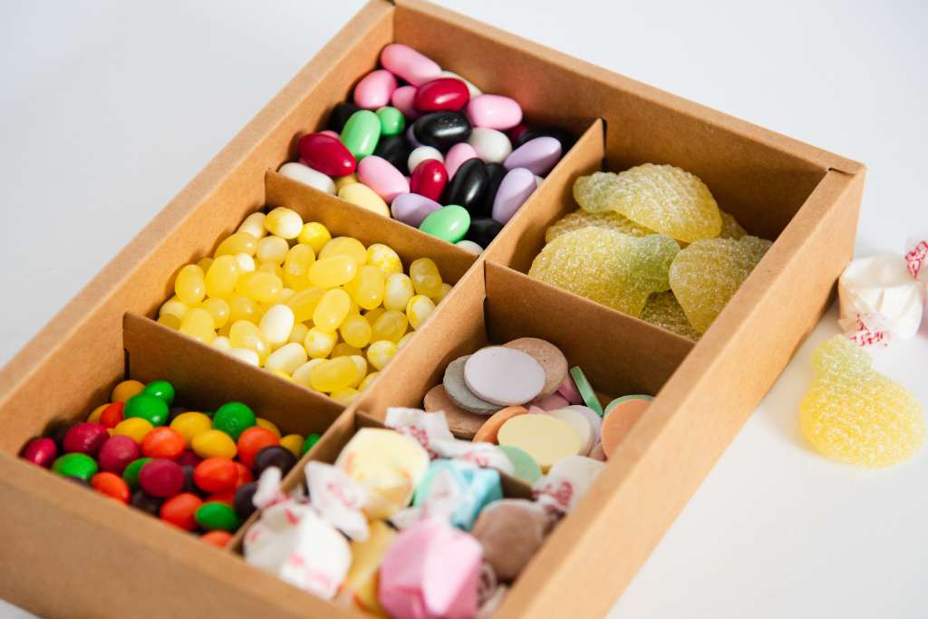 close up of a candy box with a couple pieces of candy next to it
