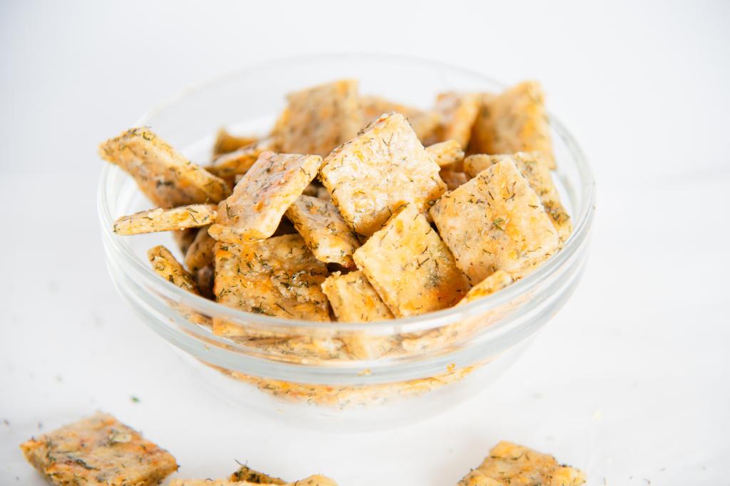 a close up of a small glass bowl of sourdough discard crackers