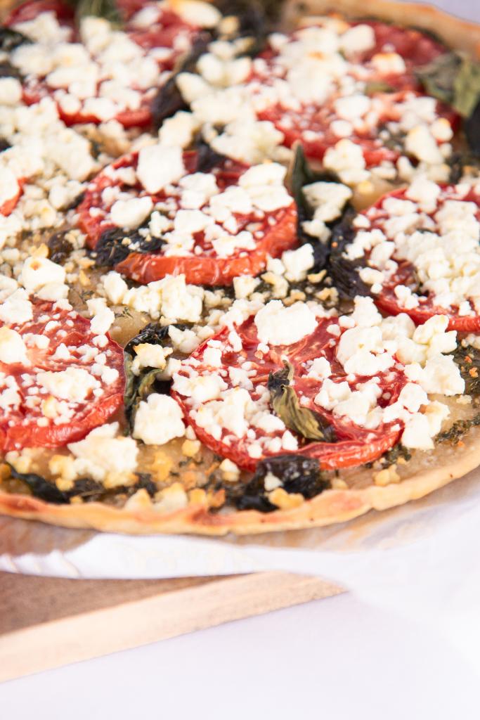 a close up on the edge of a pizza, to show the crispy crust 
