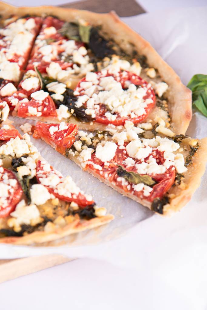 a close up of a slice on pizza, that is pulled out slightly from the rest of the pizza